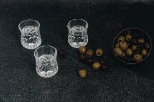 Three shots of vodka and olives